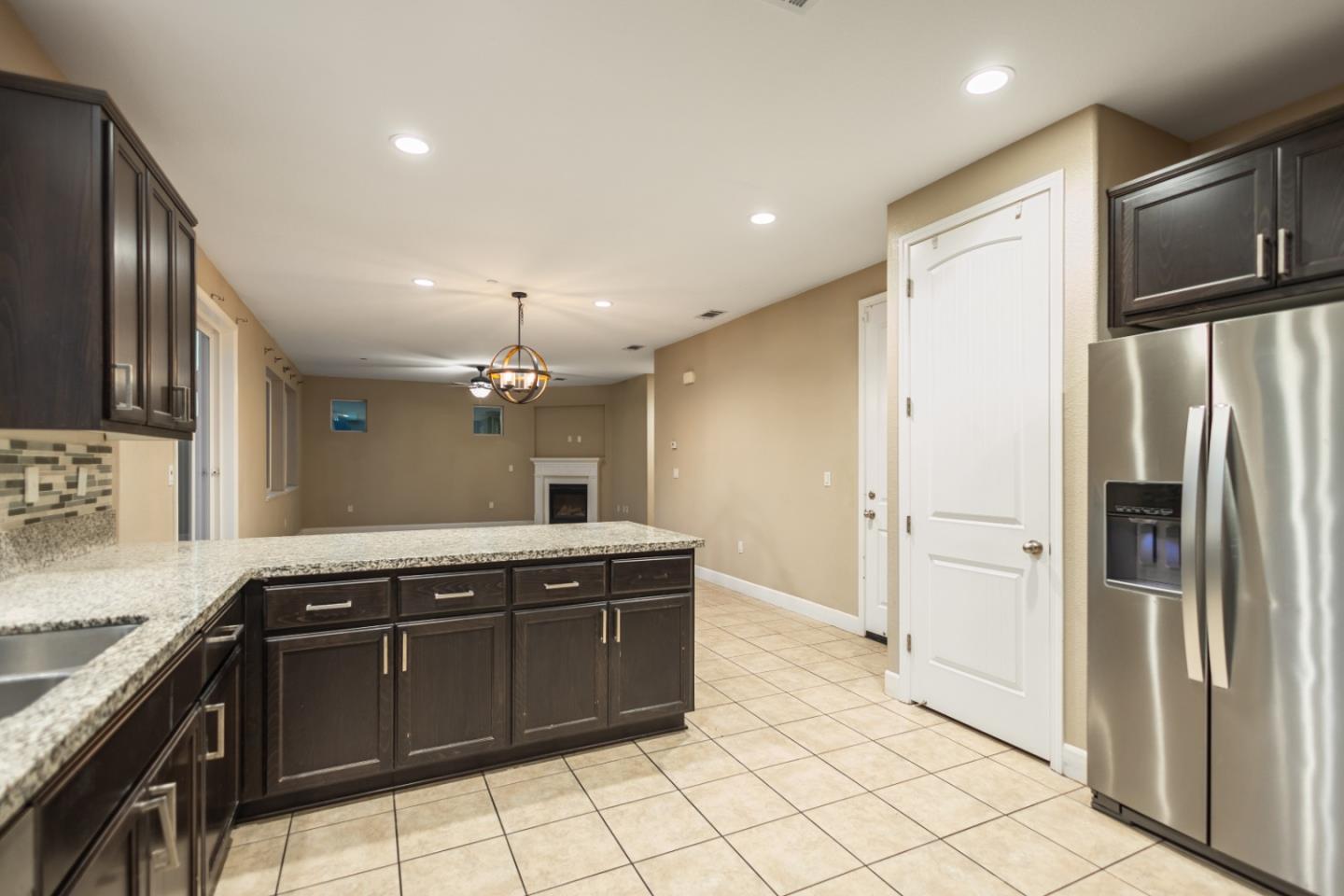 617 Copper Ridge Way Oakley, CA 94561 - Photo 13 of 27 a large kitchen with granite countertop a refrigerator and a sink