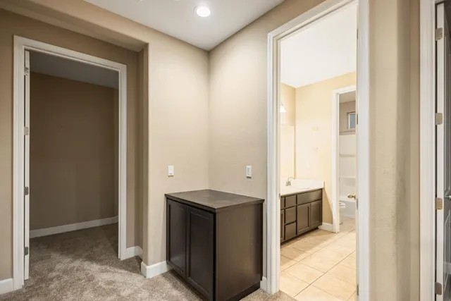 a view of kitchen with granite countertop cabinets