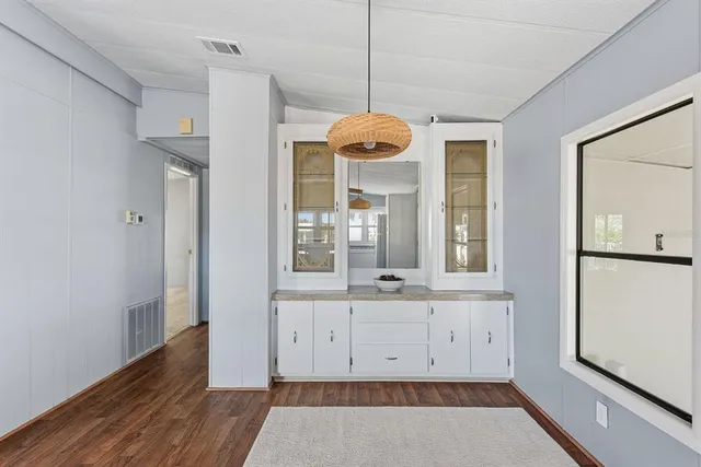 a view of cabinets a wooden floor and a window