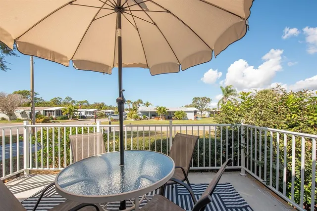 a balcony with table and chairs