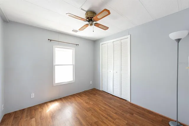 a view of a room that has a window and wooden floor