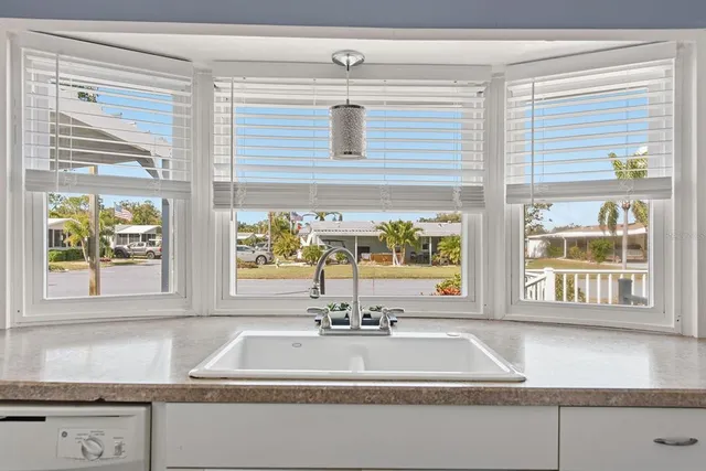 a view of a kitchen sink and cabinet