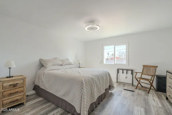a bedroom with a bed and a table