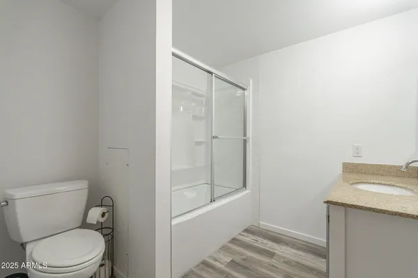 a bathroom with a toilet a sink and shower