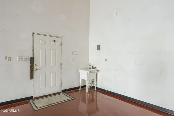 a view of a room with gym equipment and windows