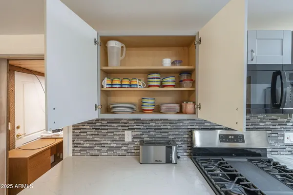 a kitchen with a refrigerator cabinets and wooden floor