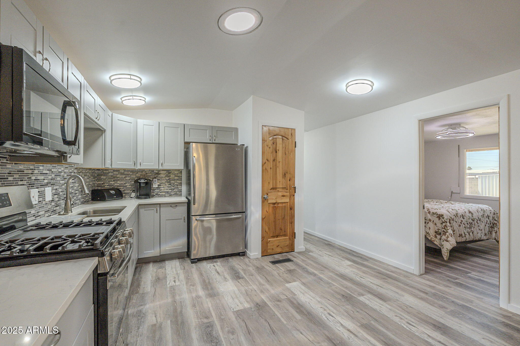 1373 East 23rd Avenue Apache Junction, AZ 85119 - Photo 34 of 53 a kitchen with a refrigerator and a stove top oven