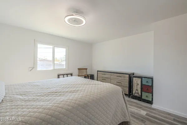 a bedroom with a bed and a dresser