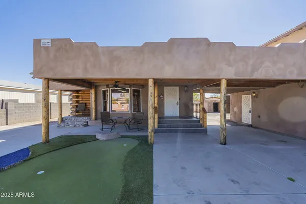 a view of an house with backyard porch and furniture
