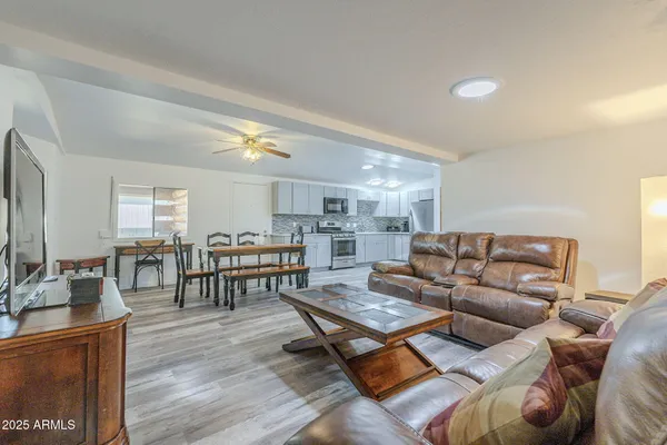 a living room with furniture and wooden floor