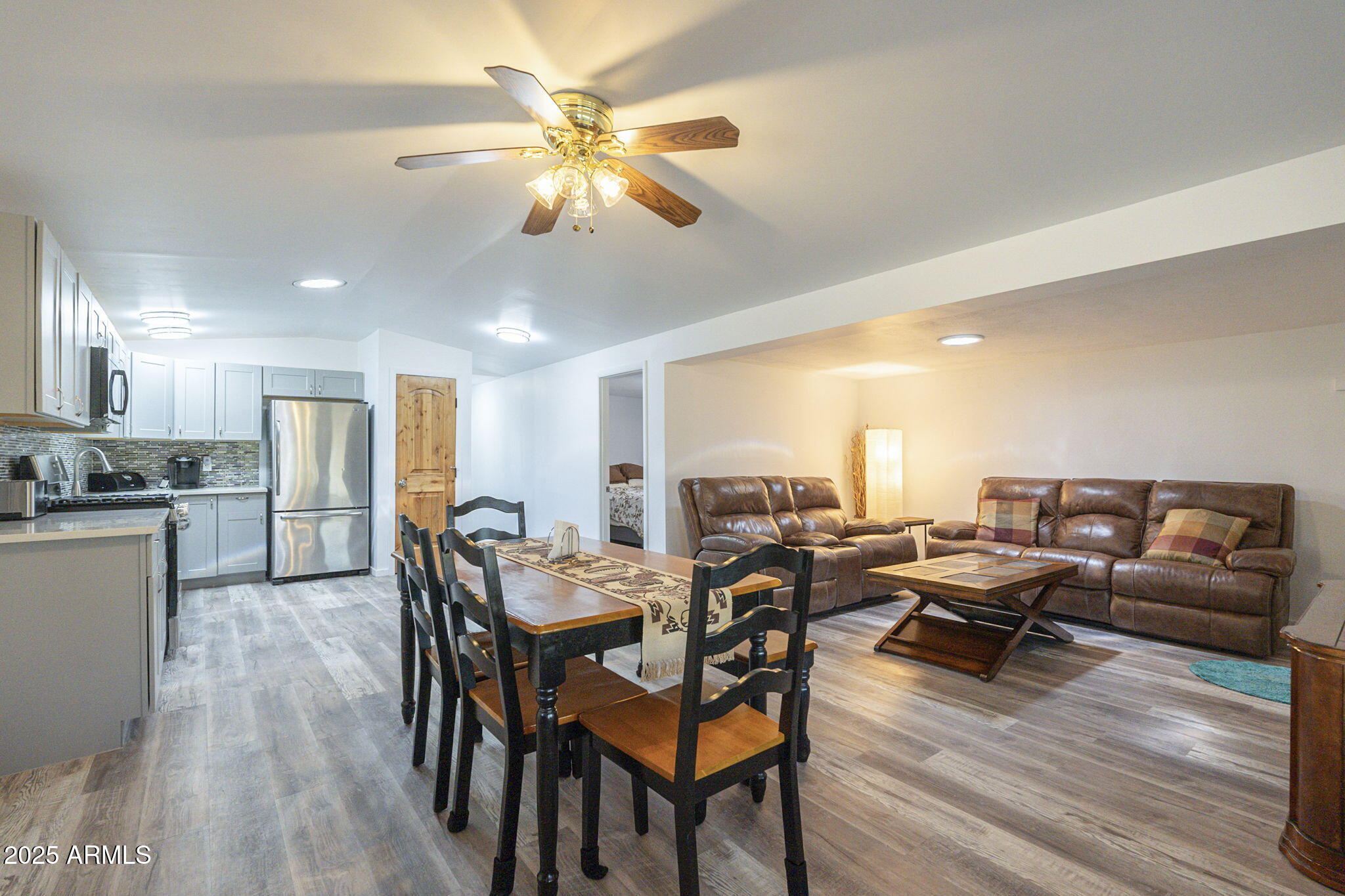 1373 East 23rd Avenue Apache Junction, AZ 85119 - Photo 7 of 53 a view of a dining room with furniture and wooden floor