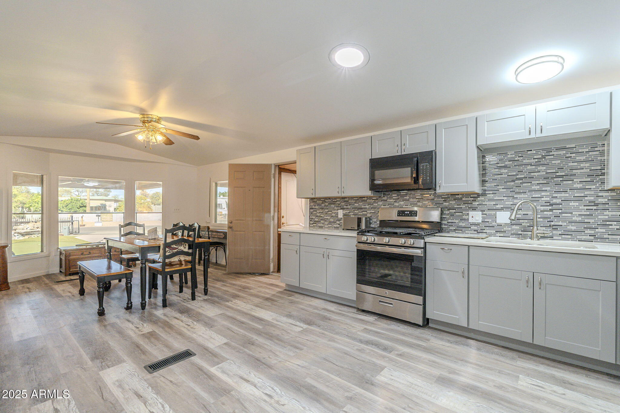 1373 East 23rd Avenue Apache Junction, AZ 85119 - Photo 8 of 53 a kitchen with a dining table chairs and white appliances
