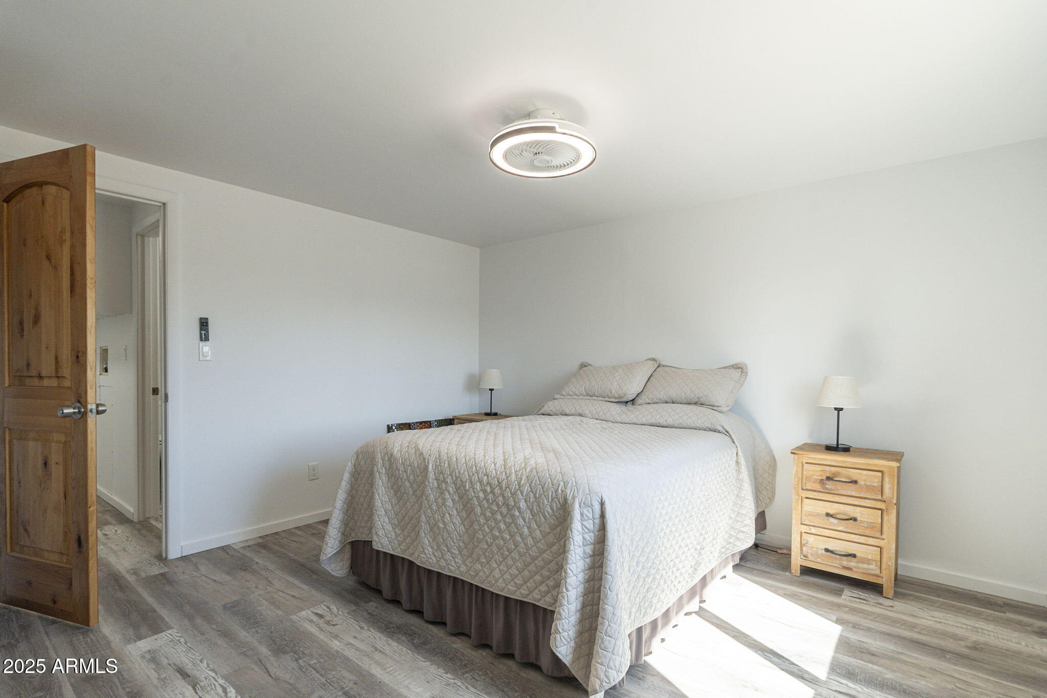1373 East 23rd Avenue Apache Junction, AZ 85119 - Photo 10 of 53 a bedroom with a bed and wooden floor