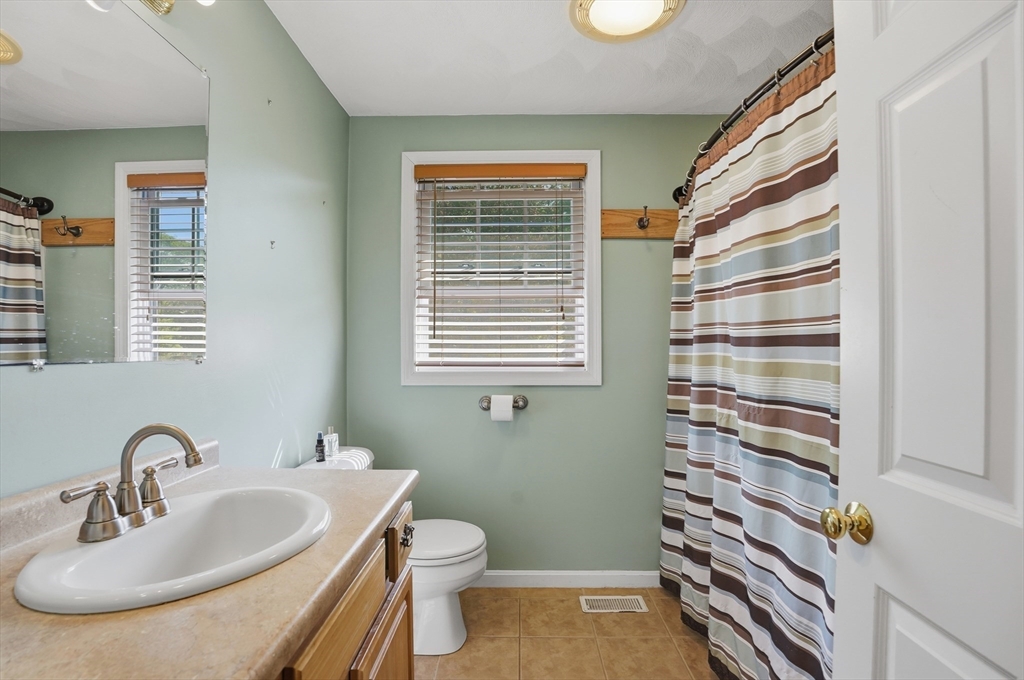 160 Gray Road Templeton, MA 01468 - Photo 27 of 42 a bathroom with a sink a toilet and a mirror