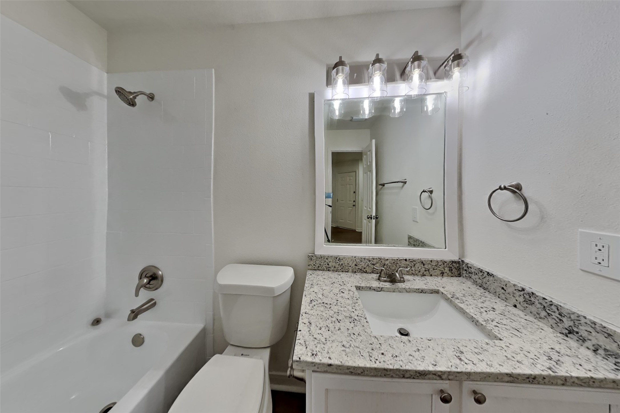 10414 Falling River Drive Houston, TX 77095 - Photo 13 of 18 a bathroom with a granite countertop sink and a mirror