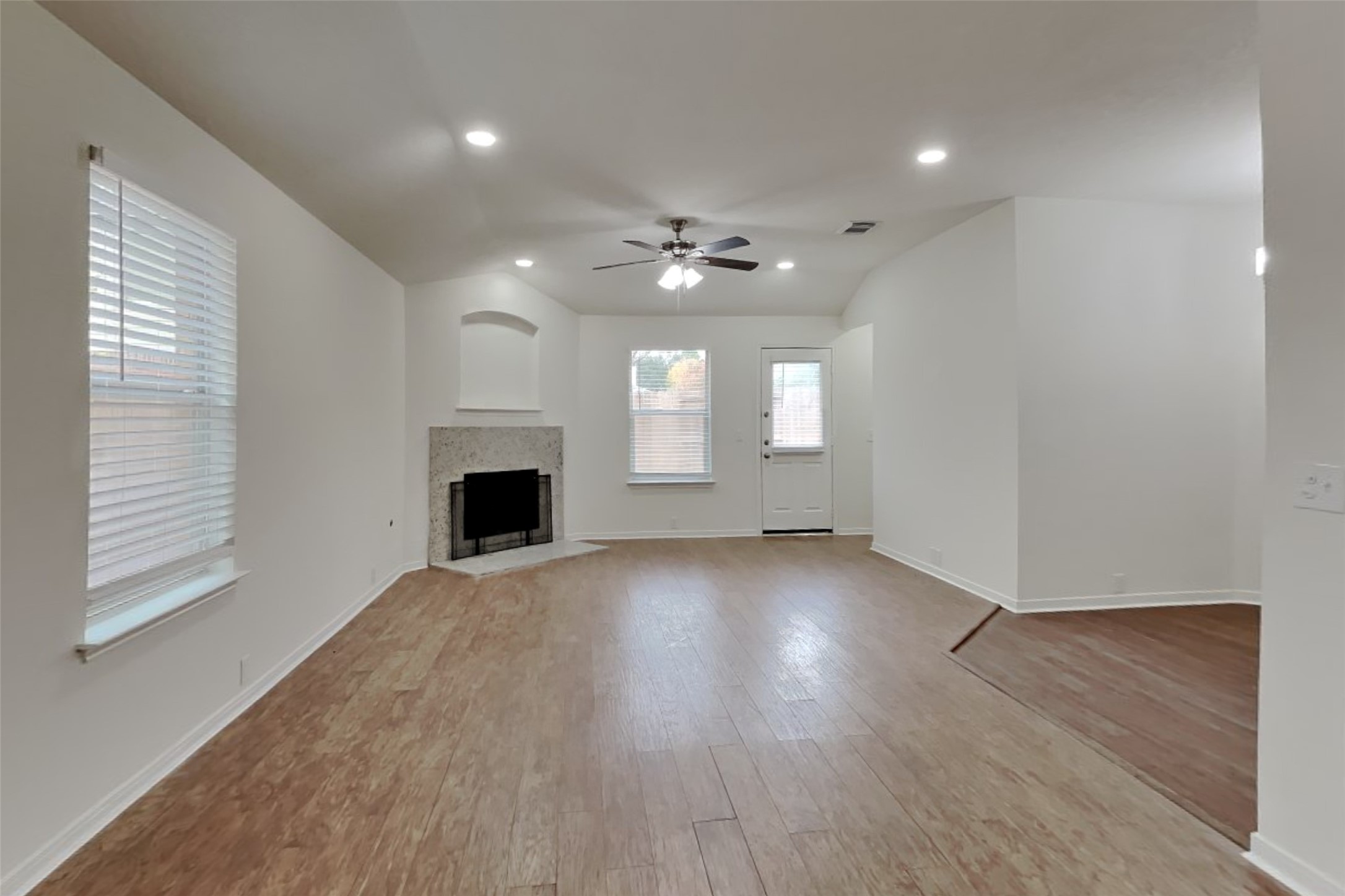 10414 Falling River Drive Houston, TX 77095 - Photo 2 of 18 an empty room with windows and fireplace