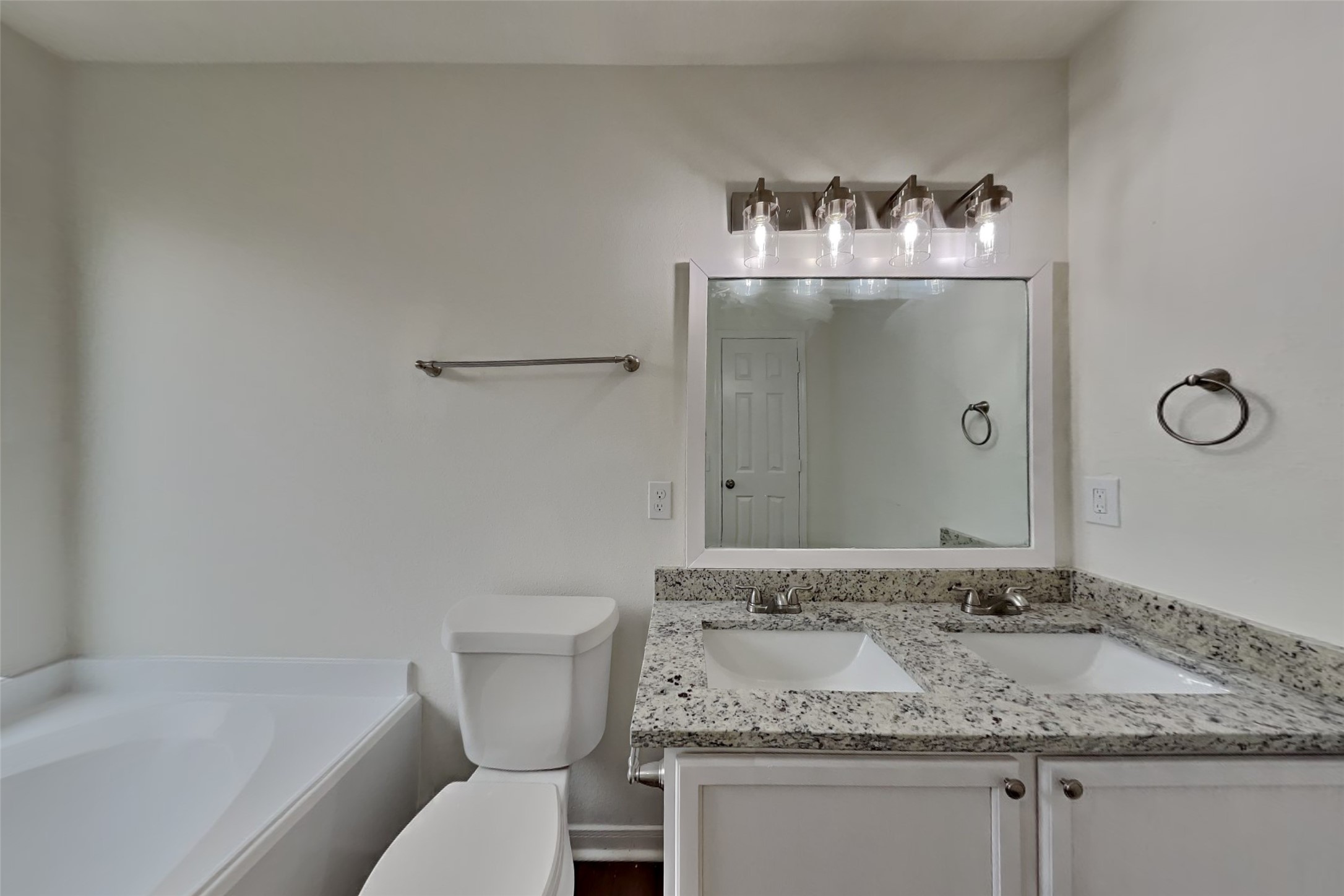 10414 Falling River Drive Houston, TX 77095 - Photo 7 of 18 a bathroom with a granite countertop sink and a mirror