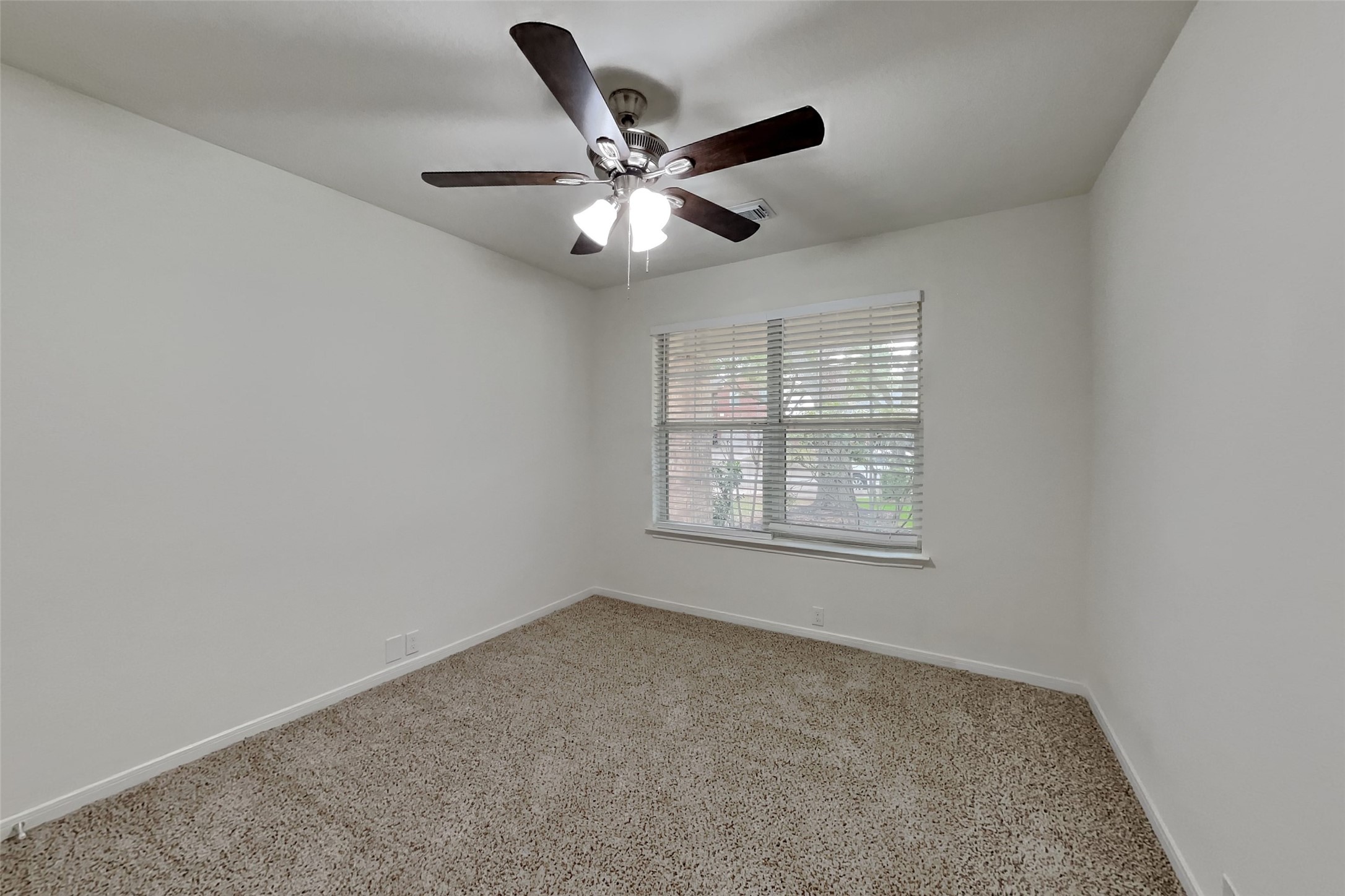 10414 Falling River Drive Houston, TX 77095 - Photo 9 of 18 an empty room with window and ceiling fan