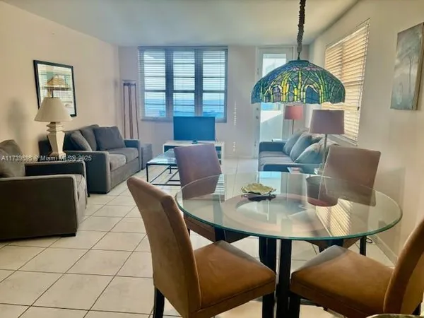 a dining room with furniture and window