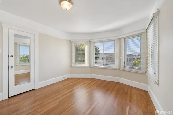 a view of a room with a window and a kitchen