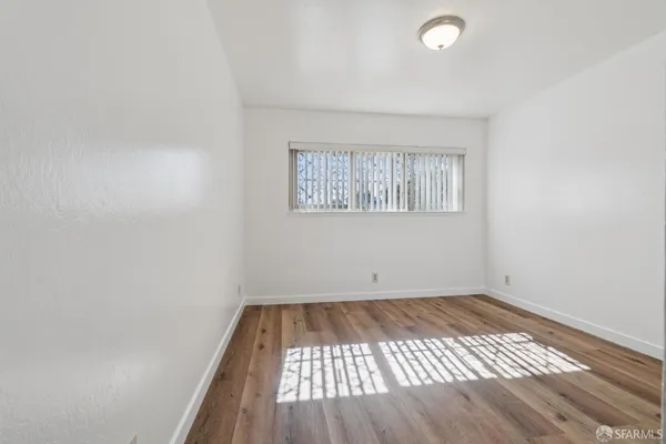 a view of a room with wooden floor
