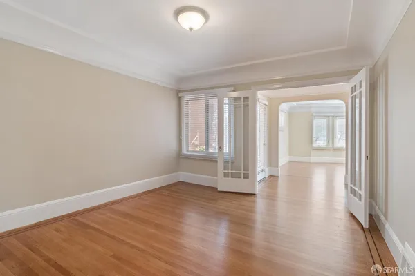wooden floor in an empty room with a window