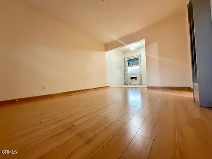 a view of a room with wooden floor