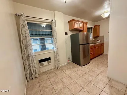 a kitchen with stainless steel appliances a refrigerator and a stove top oven