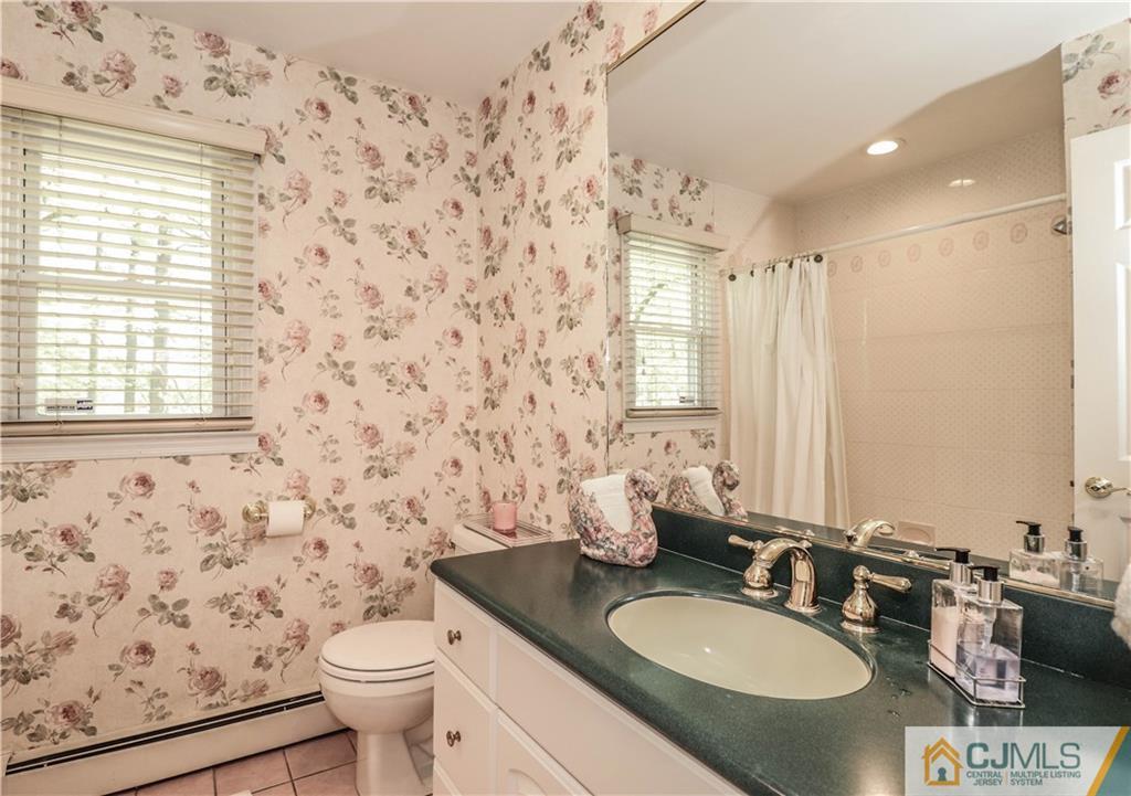 31 Sherwood Road Edison, NJ 08820 - Photo 22 of 25 a bathroom with a granite countertop toilet sink and mirror