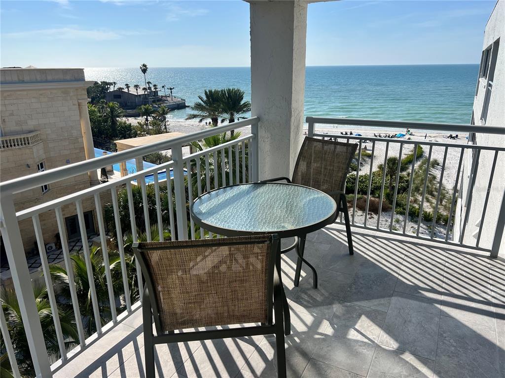 1001 Point Of Rocks Road, Unit 611 Sarasota, FL 34242 - Photo 1 of 39 a view of a balcony with chairs and wooden floor
