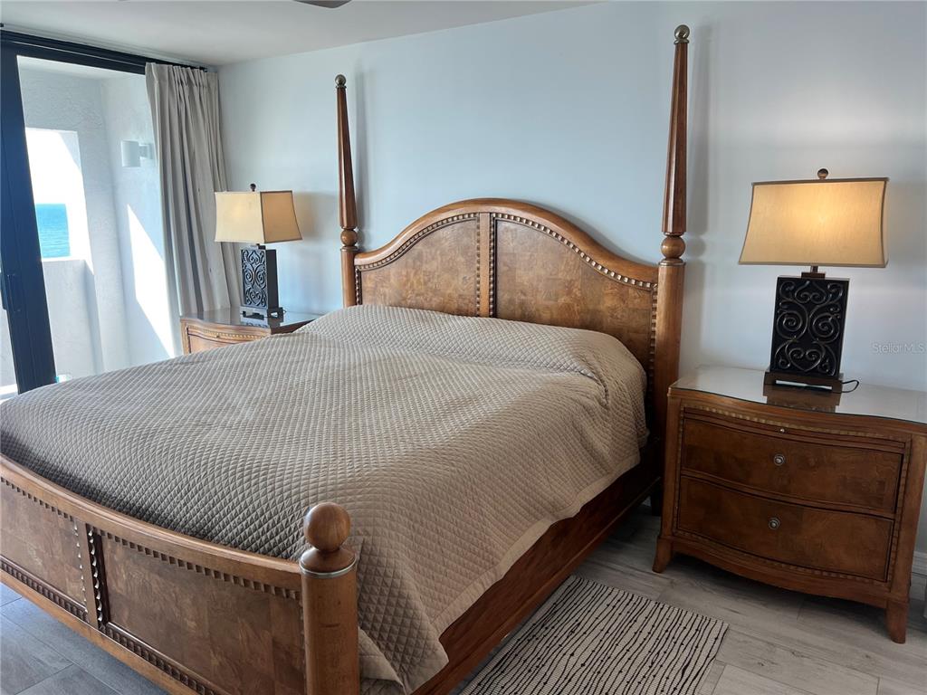 1001 Point Of Rocks Road, Unit 611 Sarasota, FL 34242 - Photo 14 of 39 a bedroom with a bed and a flat tv screen on dresser