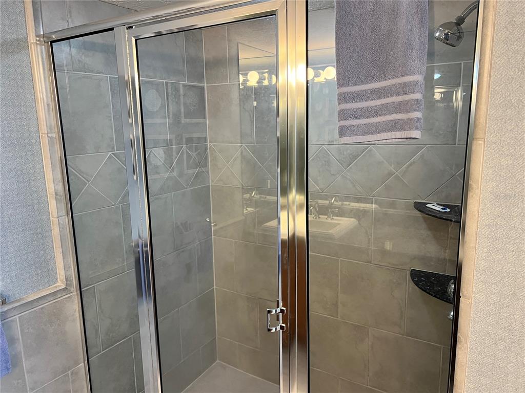1001 Point Of Rocks Road, Unit 611 Sarasota, FL 34242 - Photo 16 of 39 a bathroom with a glass shower door