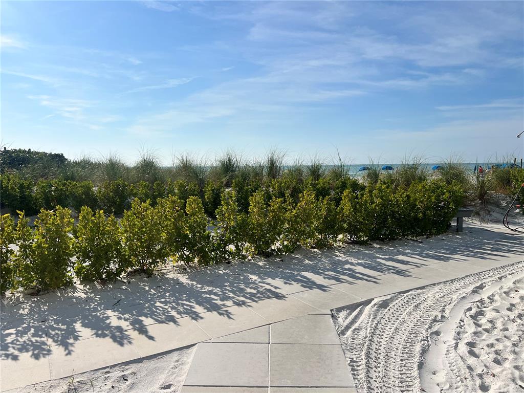 1001 Point Of Rocks Road, Unit 611 Sarasota, FL 34242 - Photo 35 of 39 a view of a pathway both side of grassy field with trees