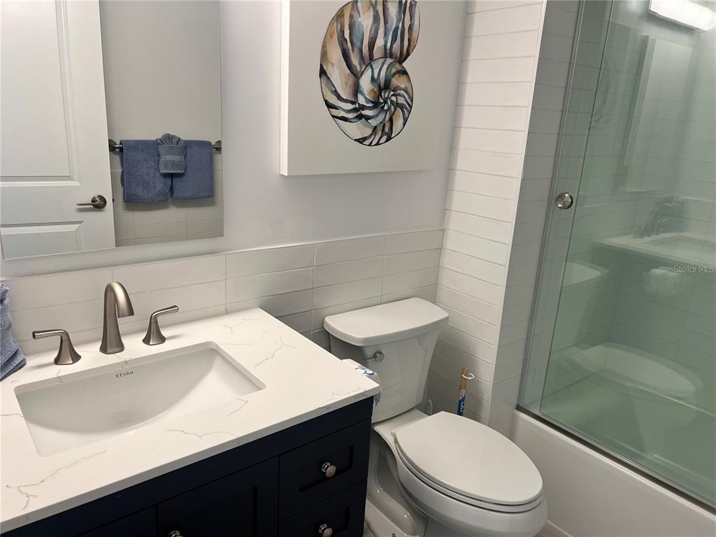 1001 Point Of Rocks Road, Unit 611 Sarasota, FL 34242 - Photo 8 of 39 a bathroom with a sink a toilet and shower