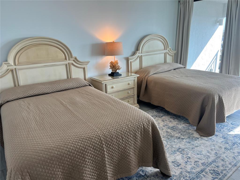 1001 Point Of Rocks Road, Unit 611 Sarasota, FL 34242 - Photo 10 of 39 a bedroom with a bed and a large window