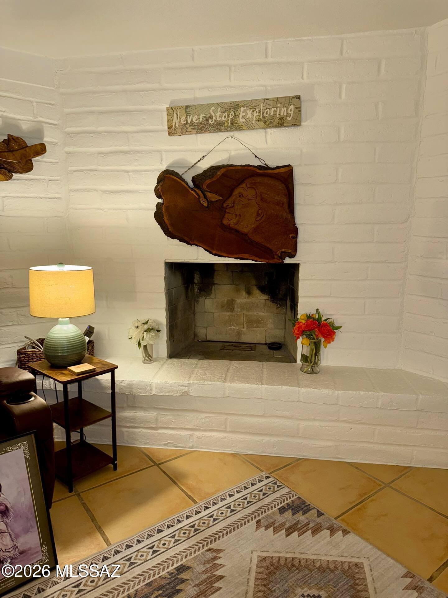 4415 North Swan Road Tucson, AZ 85718 - Photo 12 of 33 a fireplace with a rug