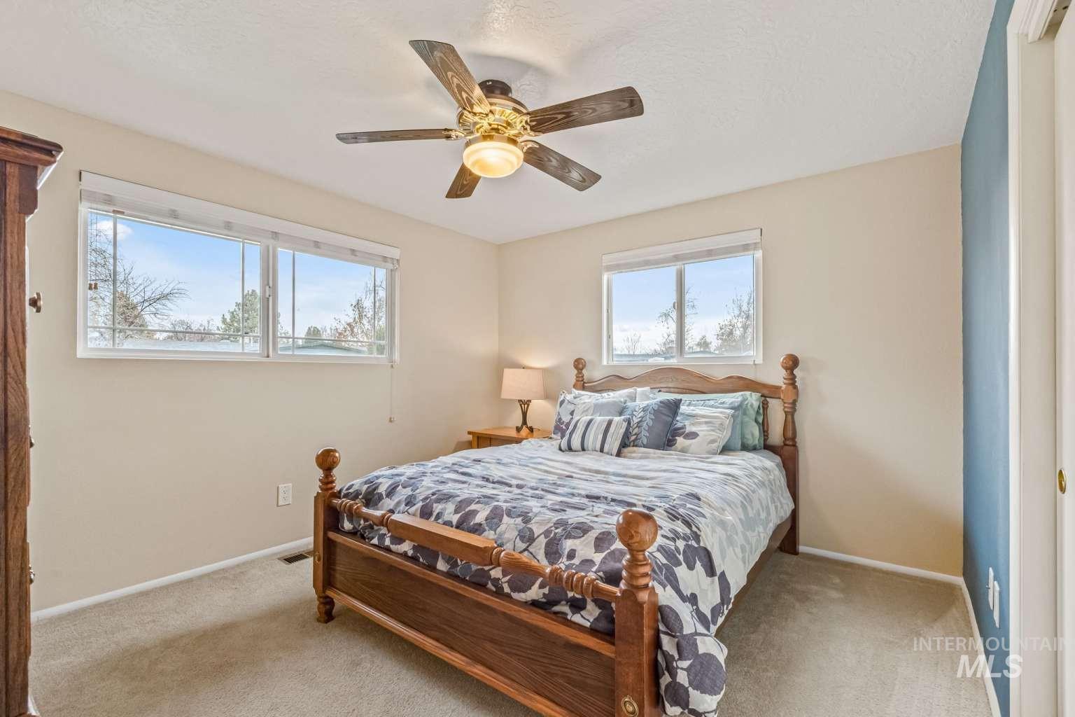 8720 Cornwall Drive Boise, ID 83704 - Photo 18 of 24 Bedroom with ceiling fan, carpet, and a textured ceiling