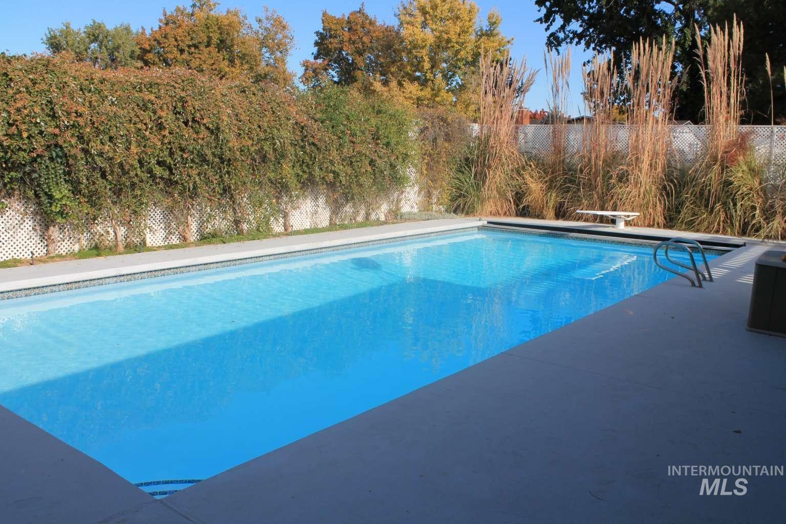 8720 Cornwall Drive Boise, ID 83704 - Photo 3 of 24 View of swimming pool featuring a patio and a diving board