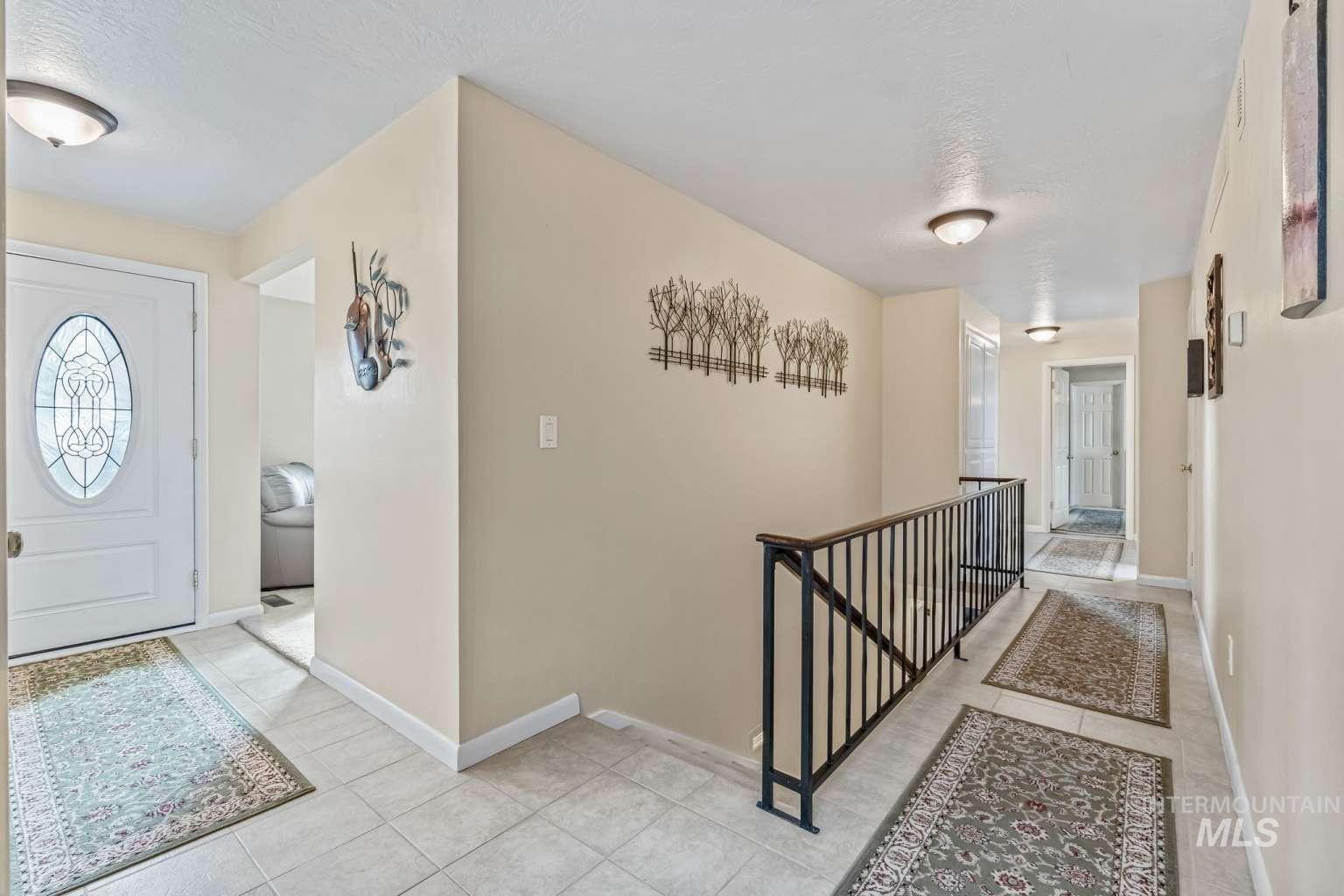 8720 Cornwall Drive Boise, ID 83704 - Photo 4 of 24 Entryway featuring baseboards and light tile patterned floors