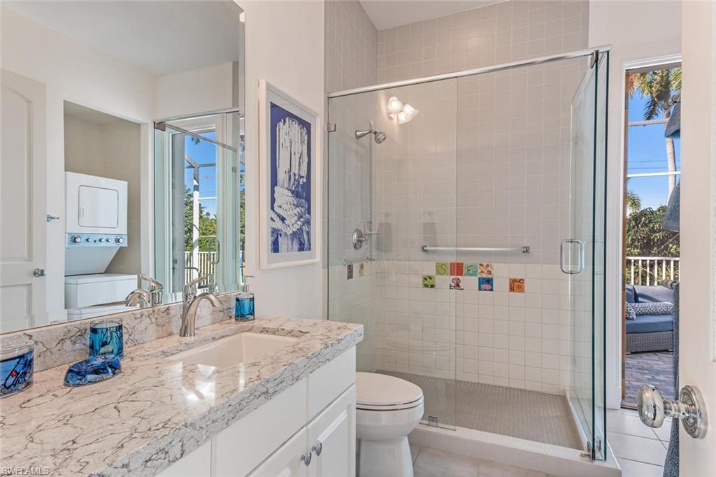 2540 Half Moon Walk Naples, FL 34102 - Photo 26 of 35 a bathroom with a granite countertop sink toilet and shower