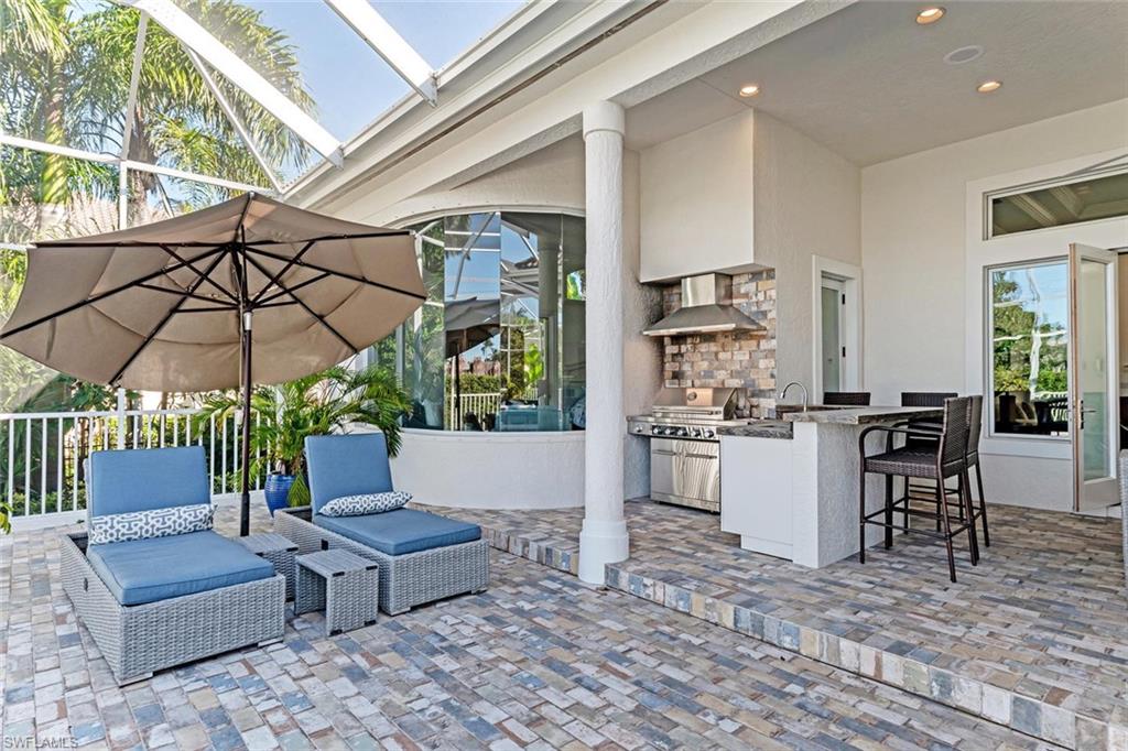 2540 Half Moon Walk Naples, FL 34102 - Photo 35 of 35 a living room with furniture a table and chairs
