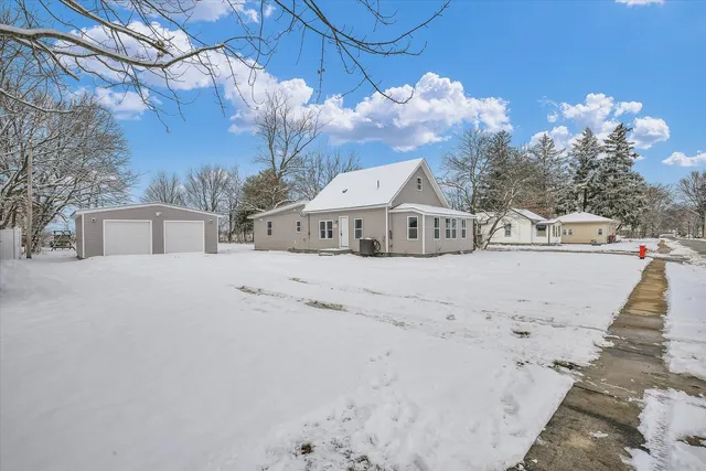 a view of a house with a snow on the road