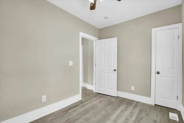 a view of an empty room with wooden floor