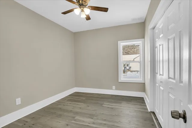 wooden floor in an empty room with a window