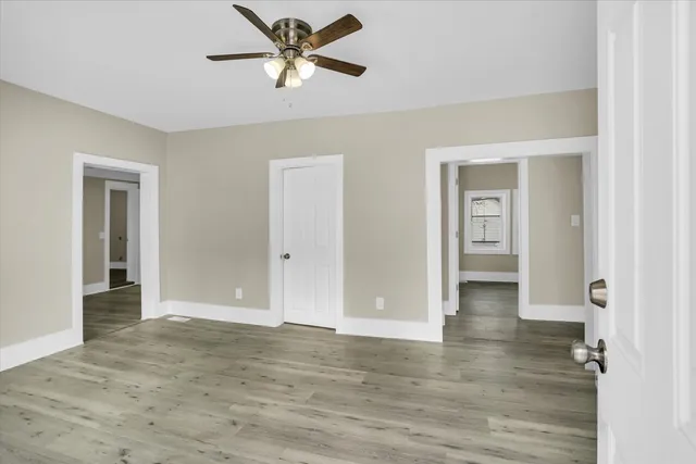 a view of empty room with wooden floor