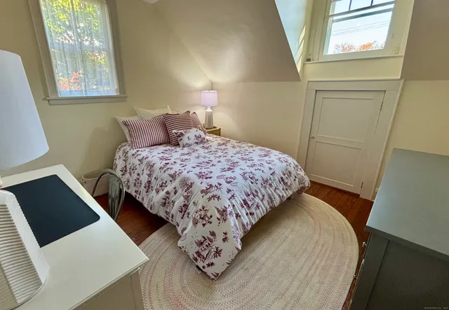 a bedroom with bed and window