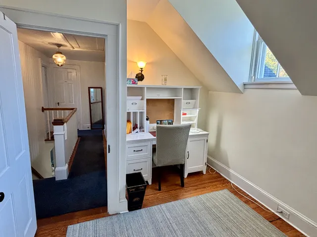 a view of living room with furniture and wooden floor