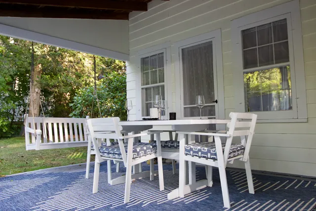 a view of a patio with a table and chairs