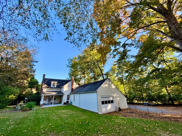 a view of a house with a yard and sitting area