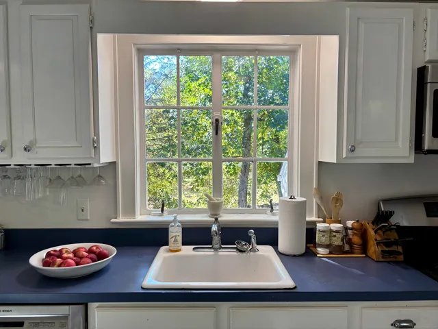 a kitchen with a stove a microwave and cabinets